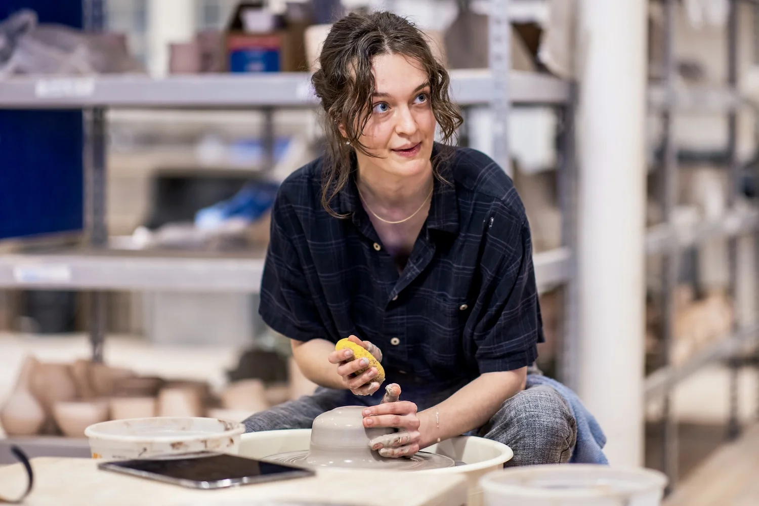 A student at the wheel in the class studio